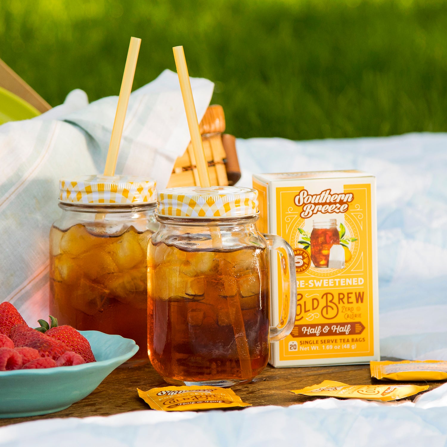 Southern Breeze Half & Half Sweet Iced Tea with iced tea jars and strawberries in a bowl