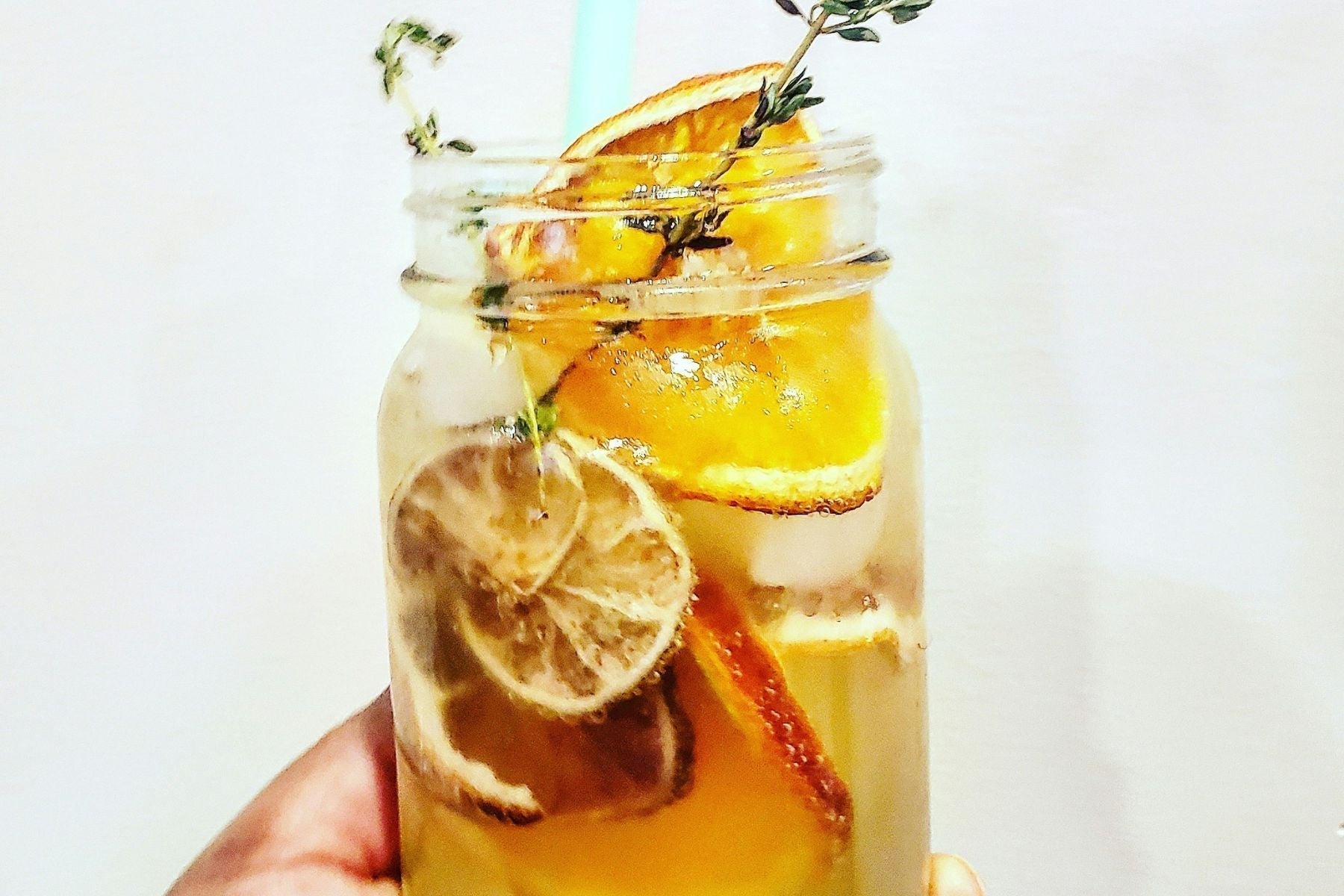 A mason jar full of Peach Sweet Tea Lemonade