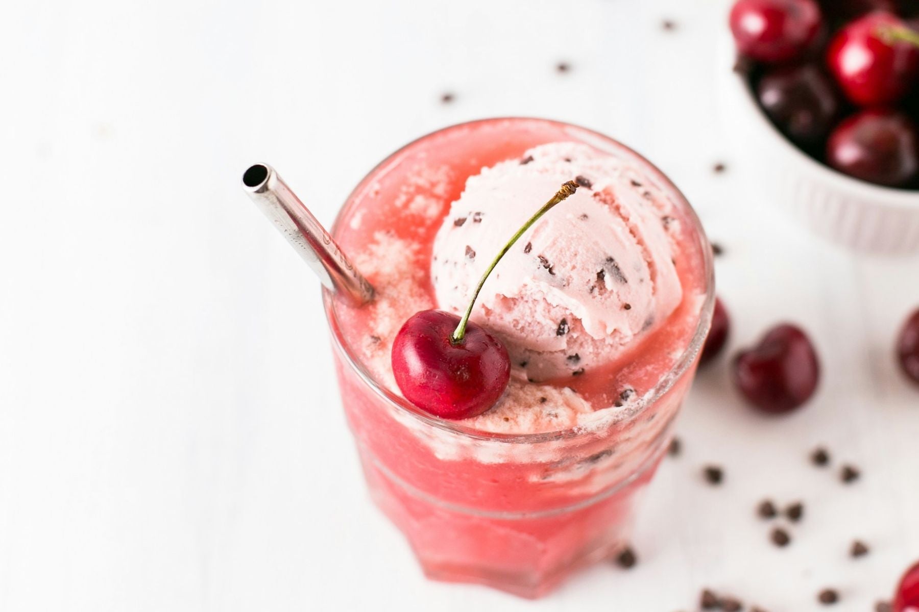 Glass of Cherry Sweet Tea Float topped with ice cream and a cherry garnish