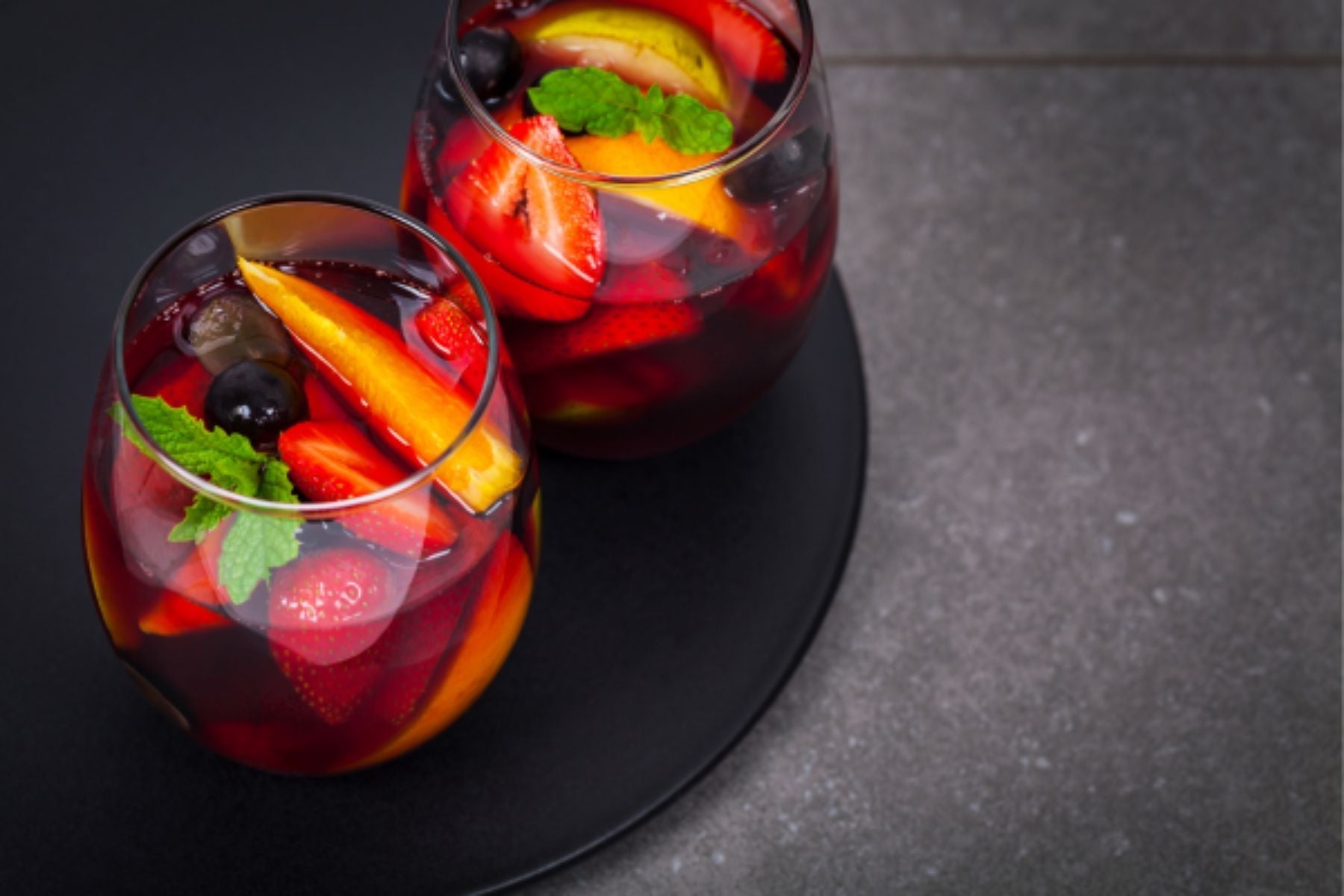 Two Glasses of Strawberry sangria with fruit 