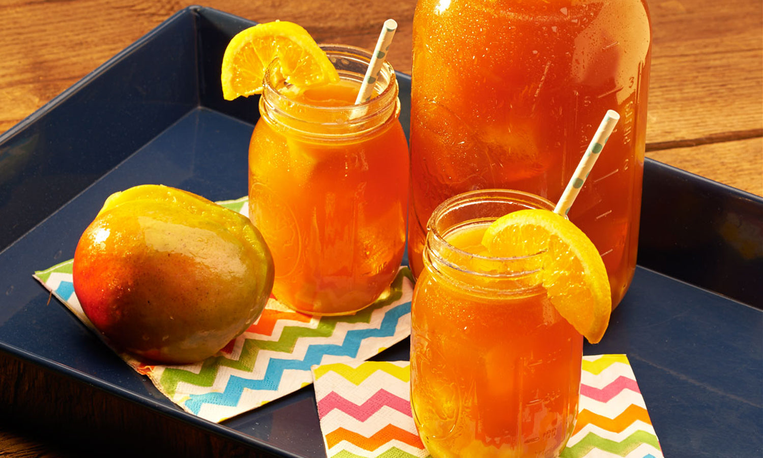 Mango Splash Sweet Tea alongside a mango