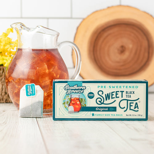 Southern Breeze Family Size Sweet Tea package with a pitcher of iced tea on a wooden surface.
