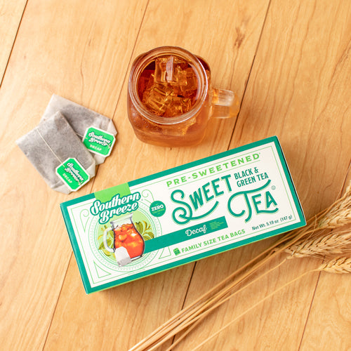 Box of Southern Breeze Decaf Sweet Tea with a glass of iced tea on a wooden surface