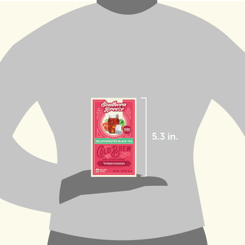 Tea box held in a hand with a measurement label on a gray shirt background
