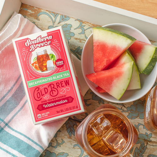 Southern Breeze tea box with watermelon slices and iced tea on a table.