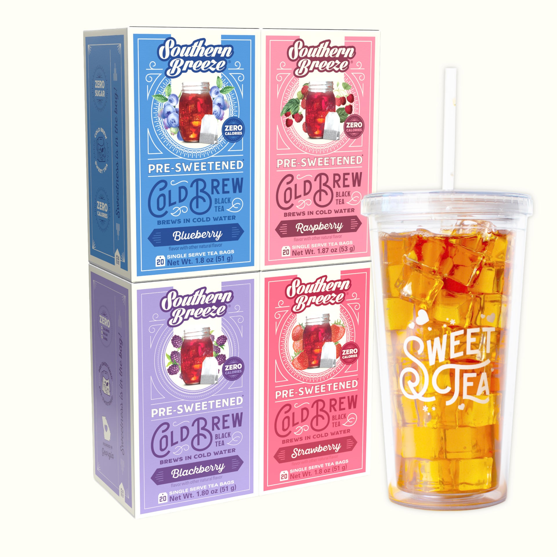 Four Southern Breeze Cold Brew tea boxes in blue, pink, and purple flavors  - Blackberry, Raspberry, Strawberry & Blueberry flavor - arranged next to a clear plastic tumbler with a straw filled with iced tea, on a light cream background.