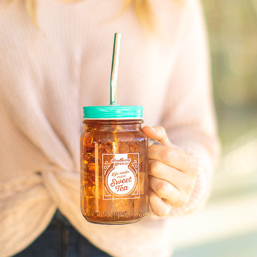 mason jar with handle, lid, and straw that reads life needs more sweet tea