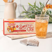Box of Southern Breeze pre-sweetened mango black sweet tea with a glass of tea being poured
