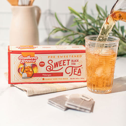 Box of Southern Breeze pre-sweetened mango black sweet tea with a glass of tea being poured